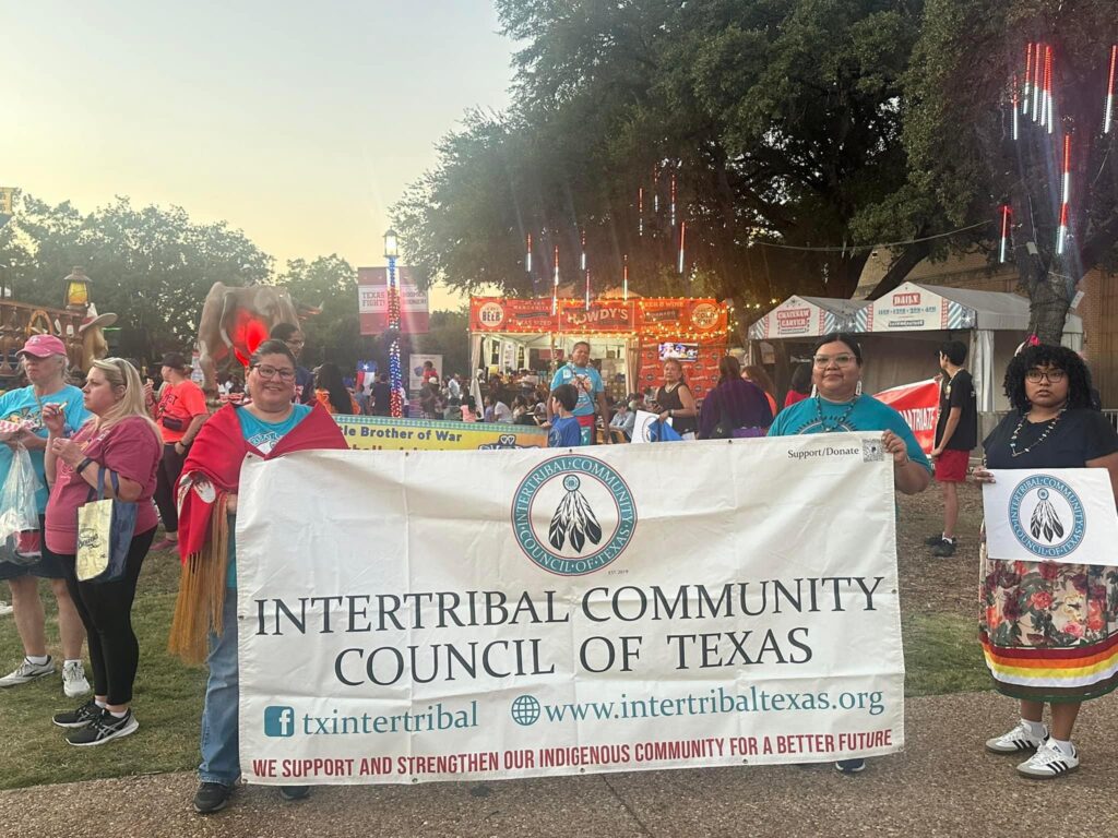ICCT members holding the Intertribal Community Council of Texas banner at a community event.