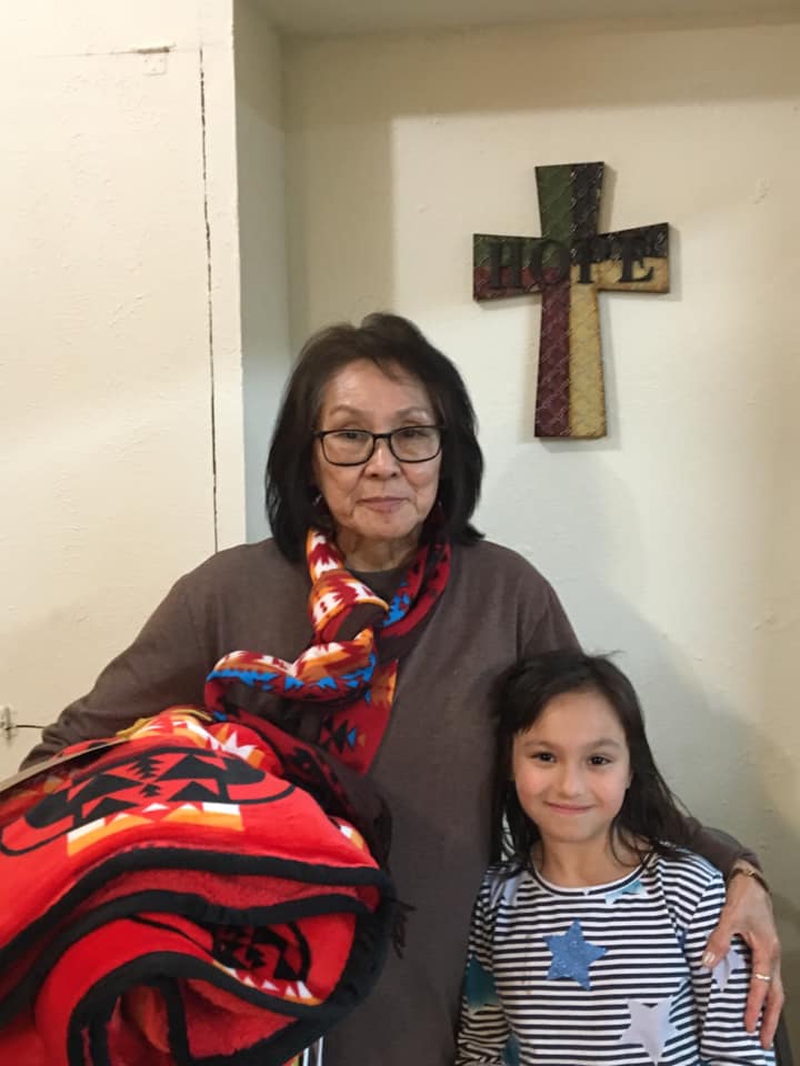 American Indian elder wrapped in blanket during ICCT community event.