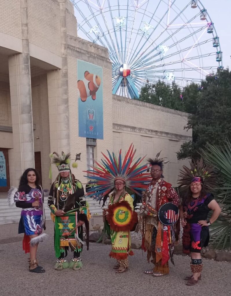 ICCT community members wearing traditional regalia during a cultural celebration.